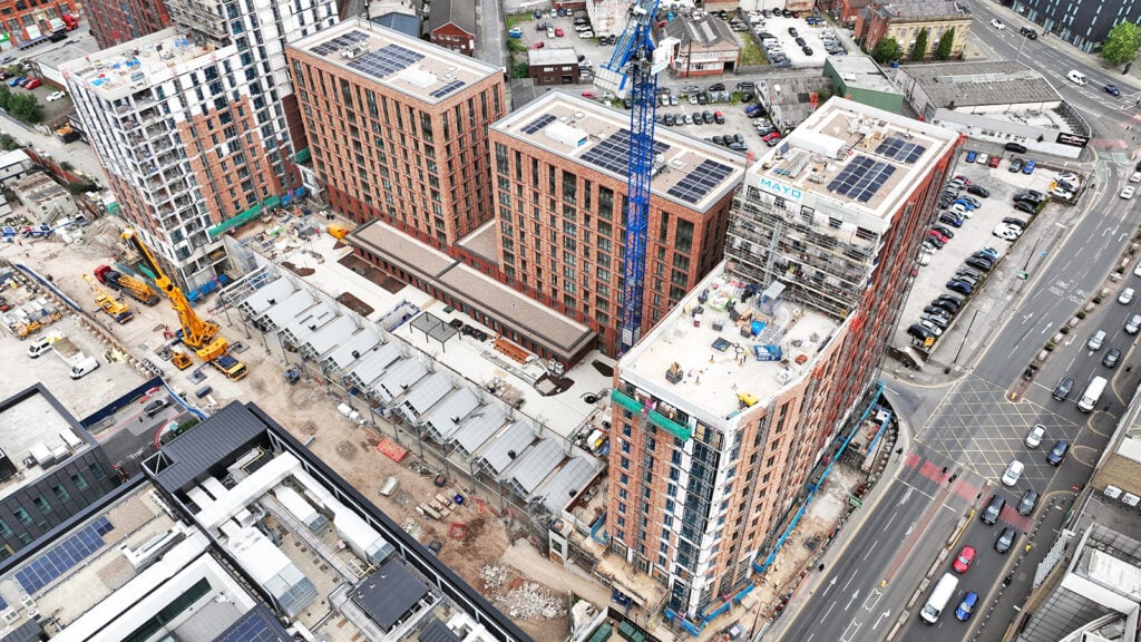 Aerial view of urban construction site with cranes.