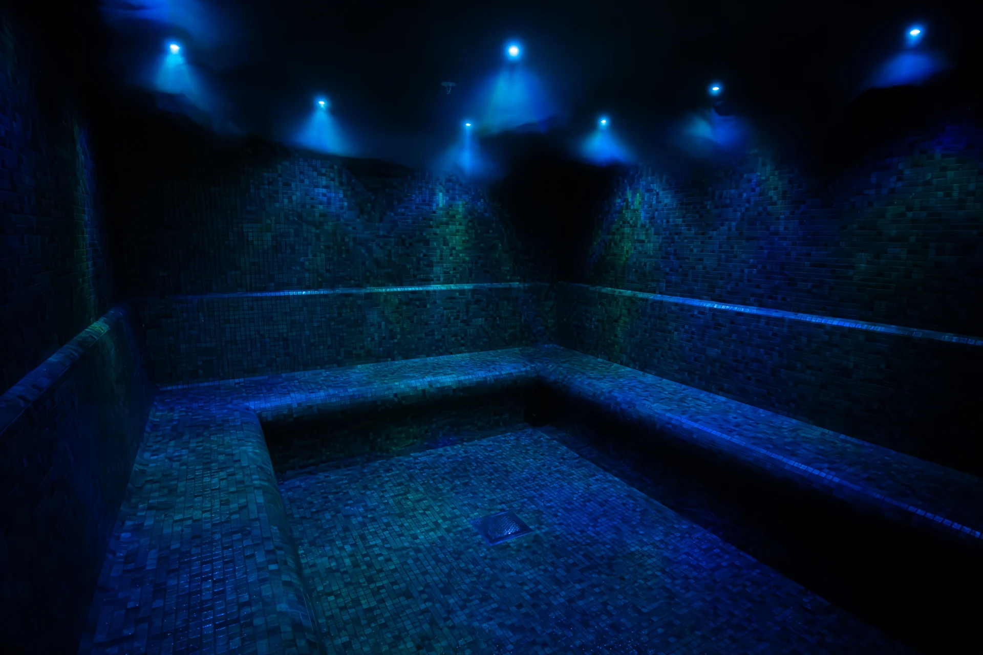 Dimly lit blue-tiled steam room