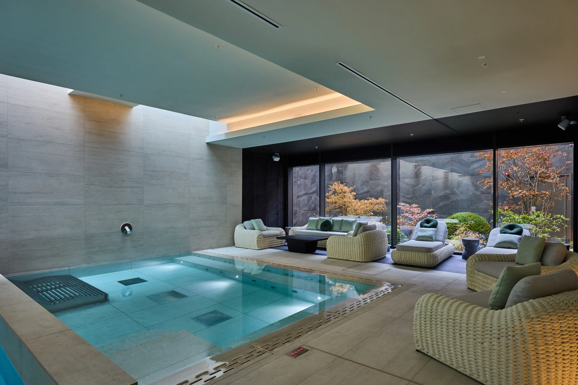 Luxurious indoor pool area with modern seating