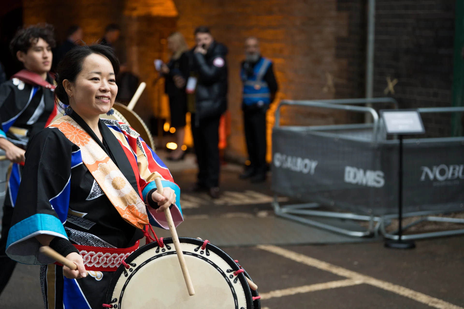 Drummer in colorful outfit performing outdoors