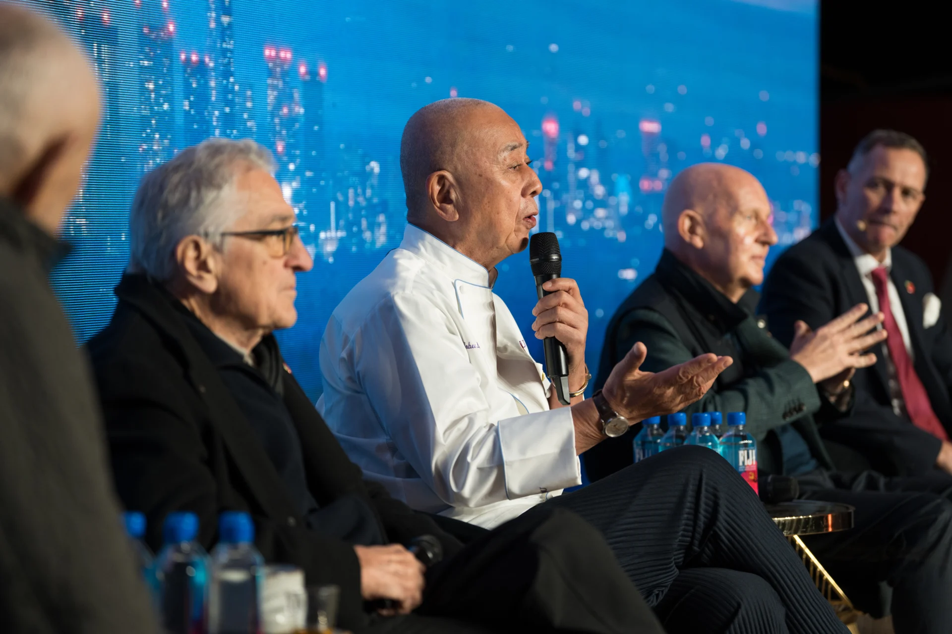 Panel discussion with speakers and microphone