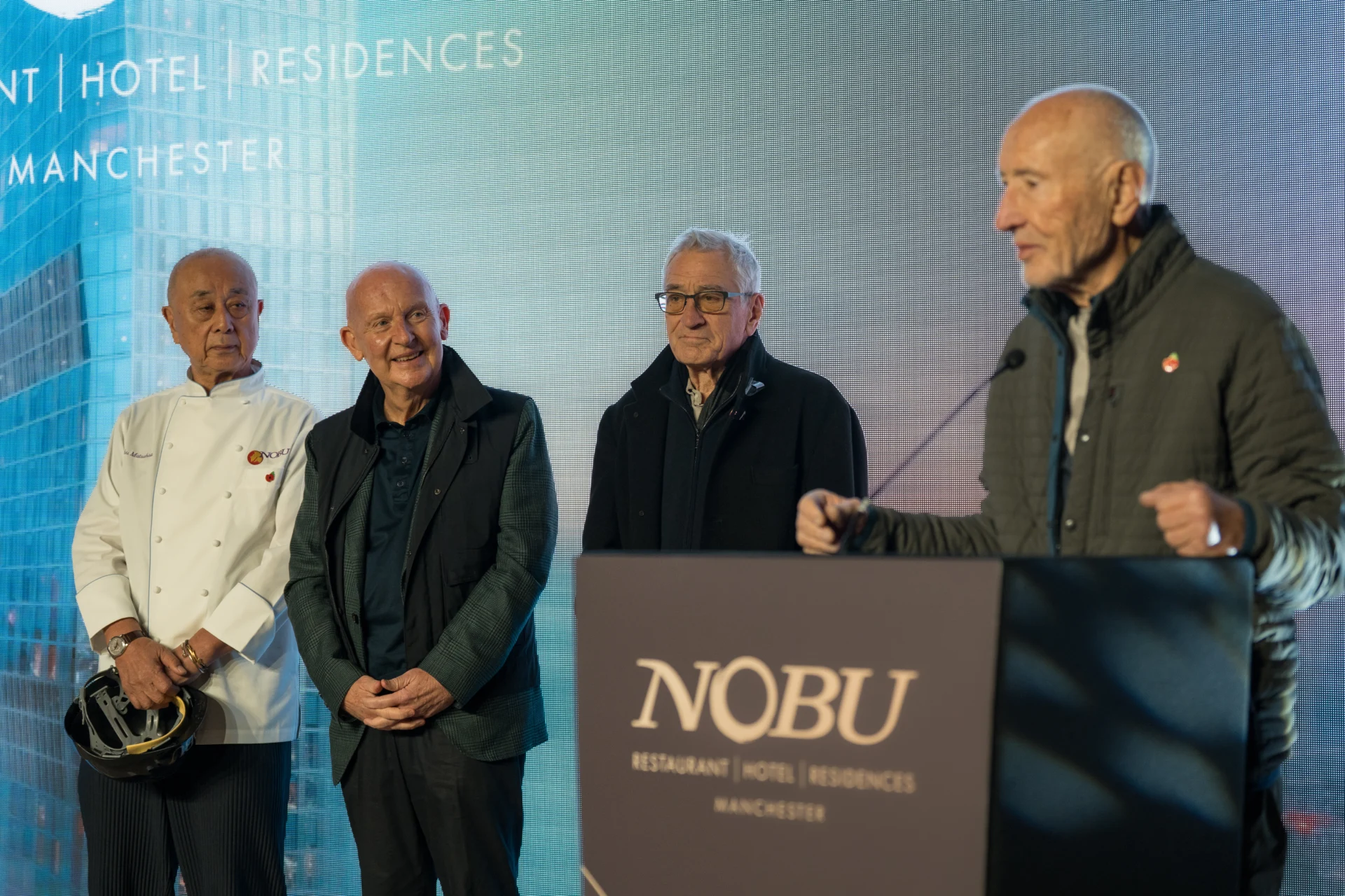 Four men speaking at Nobu Manchester event.