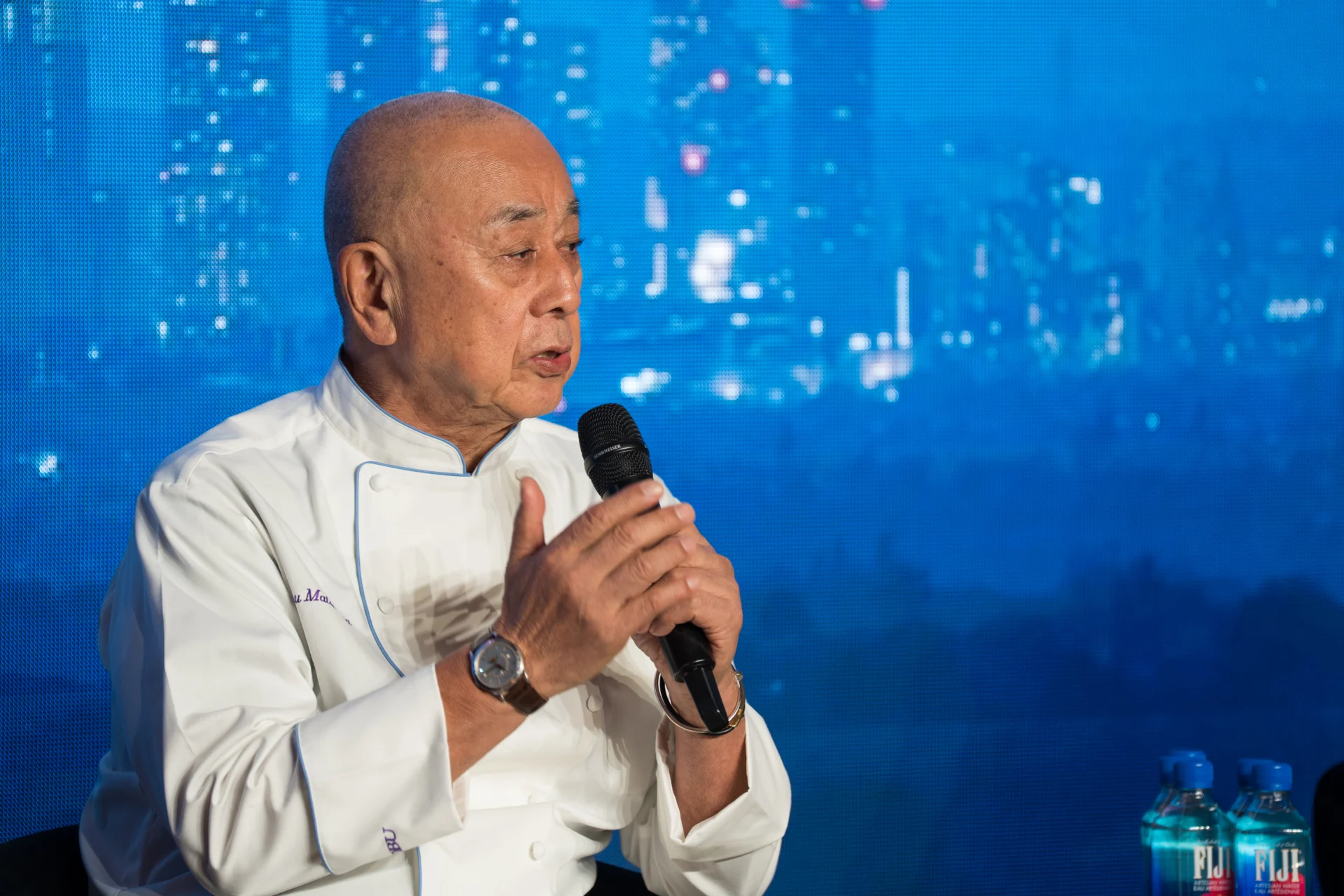 Chef speaking on stage with microphone