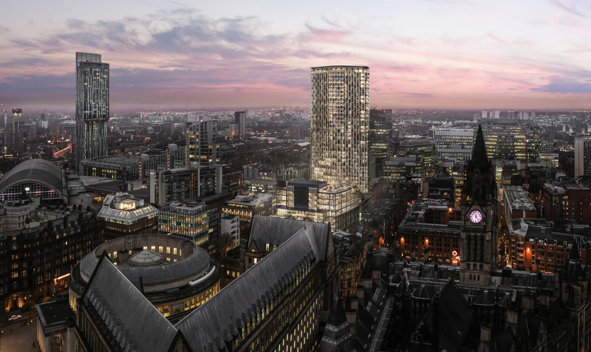 Manchester skyline at dusk with illuminated towers and clock tower